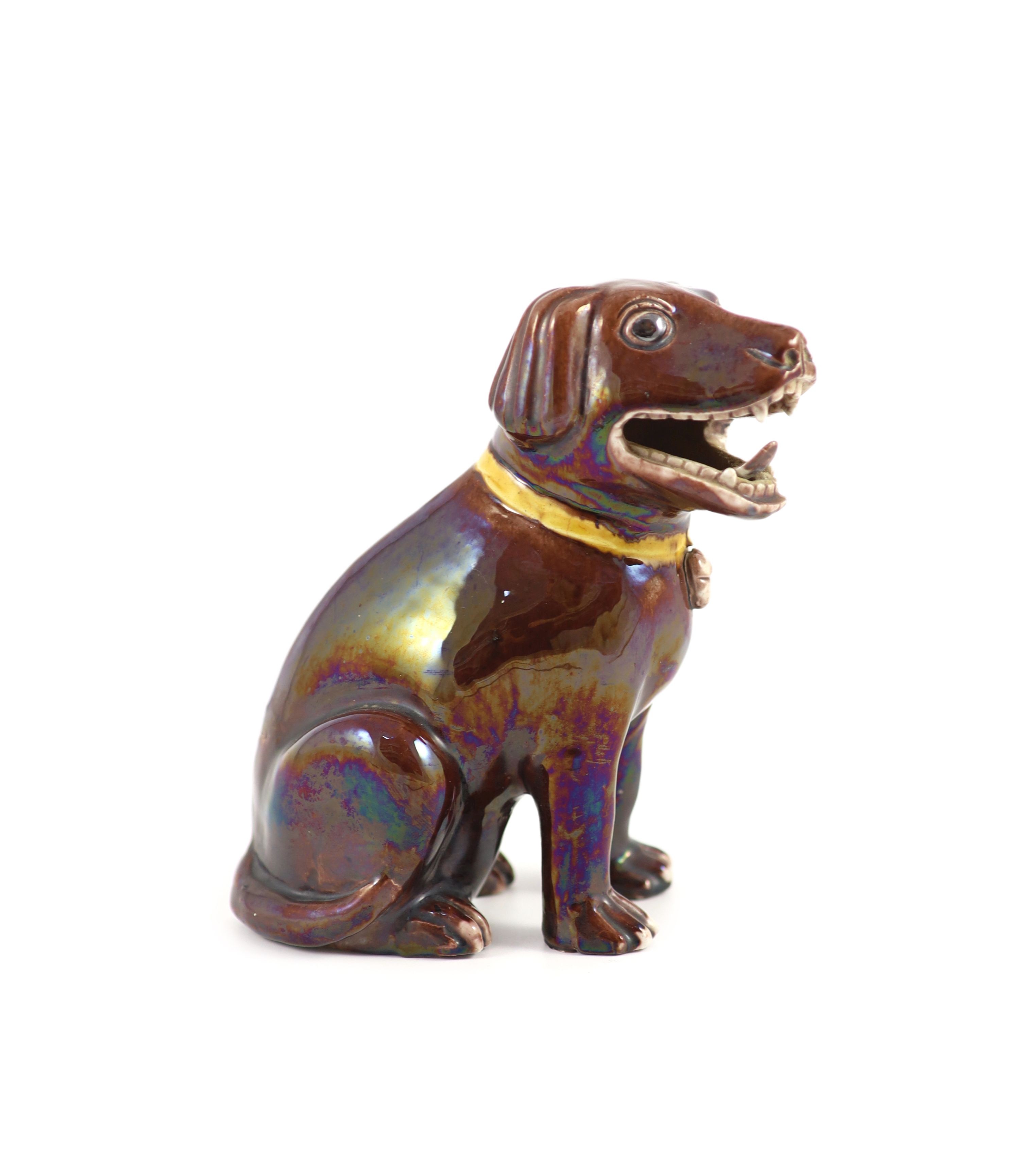 A Chinese brown glazed porcelain model of a seated dog, Qianlong period, 17.5 cm high